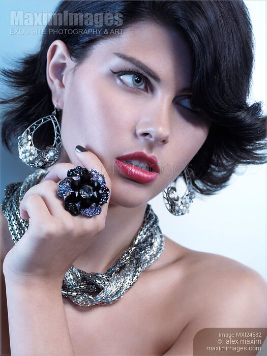 Stock photo of Portrait of a Beautiful Woman Wearing Jewelry Buy commercial use license at MaximImages