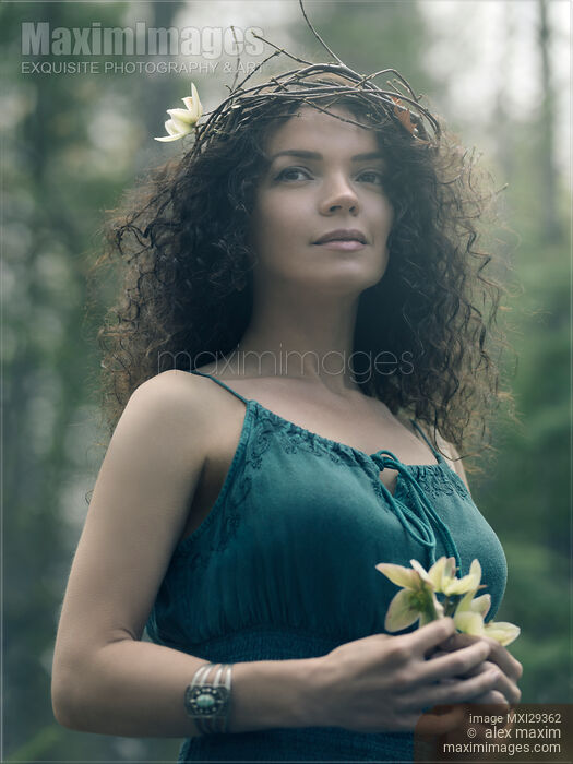 Stock photo of Portrait of a beautiful woman with a wreath on her head and a flower in her hands Buy commercial use license at MaximImages