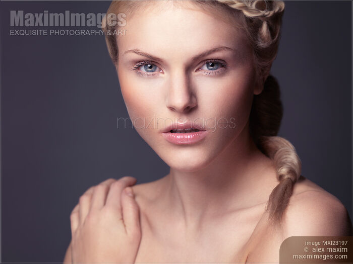 Portrait of a beautiful young woman looking at camera Stock photo of Portrait of a beautiful young woman looking at camera Buy commercial use license at MaximImages