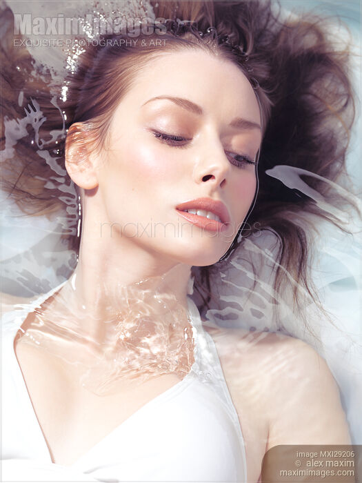 Portrait of a beautiful young woman with fresh clean face lying in water Stock photo of Portrait of a beautiful young woman with fresh clean face lying in water Buy commercial use license at MaximImages