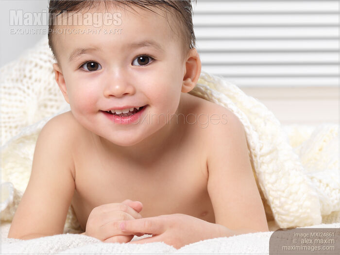 Portrait of a cute little boy under a blanket Stock photo of Portrait of a cute little boy under a blanket Buy commercial use license at MaximImages