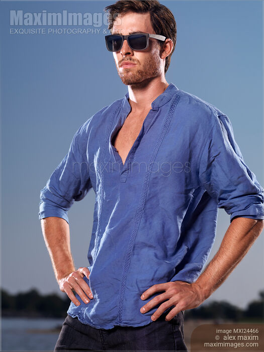 Stock photo of Portrait of a man in blue shirt at the beach Buy commercial use license at MaximImages