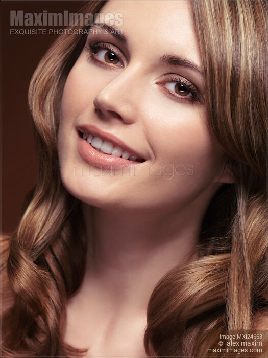 Portrait of a smiling beautiful woman with long brown hair Stock photo of Portrait of a smiling beautiful woman with long brown hair Buy commercial use license at MaximImages