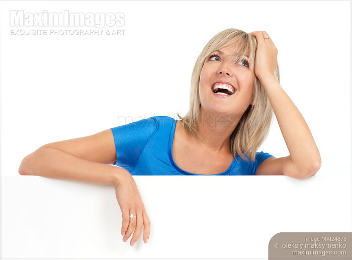 Stock photo of Portrait of a smiling young woman with daydreaming expression Buy commercial use license at MaximImages