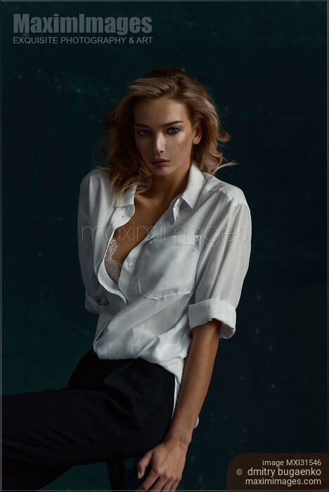 Portrait of a woman with an expressive look in an unbuttoned white shirt Stock photo of Portrait of a woman with an expressive look in an unbuttoned white shirt Buy commercial use license at MaximImages