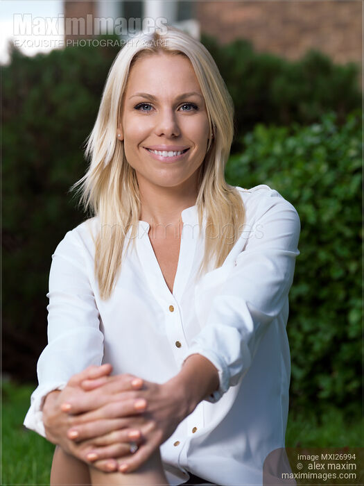 Stock photo of Portrait of a young smiling blond woman Buy commercial use license at MaximImages