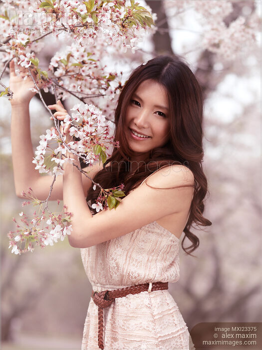 Portrait of a Young Smiling Woman Standing at a Cherry Tree Stock photo of Portrait of a Young Smiling Woman Standing at a Cherry Tree Buy commercial use license at MaximImages