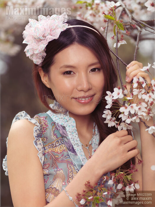 Portrait of a Young Smiling Woman Standing at a Cherry Tree Stock photo of Portrait of a Young Smiling Woman Standing at a Cherry Tree Buy commercial use license at MaximImages