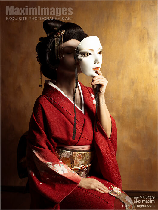 Stock photo of Portrait of beautiful geisha holding white theatrical mask in her hand in front of her face Buy commercial use license at MaximImages