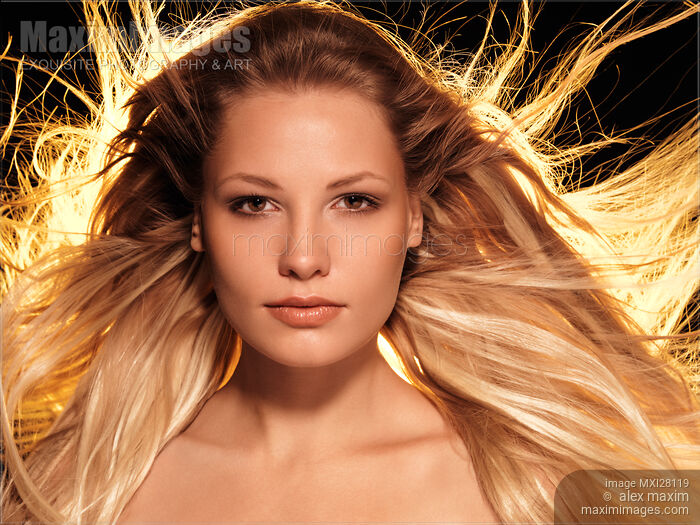 Portrait of beautiful woman face with glowing golden blond hair Stock photo of Portrait of beautiful woman face with glowing golden blond hair Buy commercial use license at MaximImages