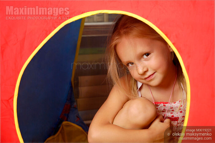 Stock photo of Portrait of little girl in her tent Buy commercial use license at MaximImages