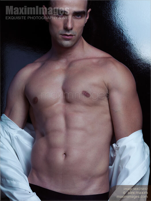 Portrait of muscular sexy man taking off his shirt Stock photo of Portrait of muscular sexy man taking off his shirt Buy commercial use license at MaximImages