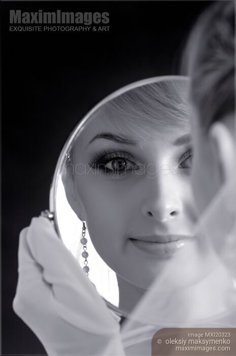 Stock photo of Portrait of young bride looking in a mirror Buy commercial use license at MaximImages