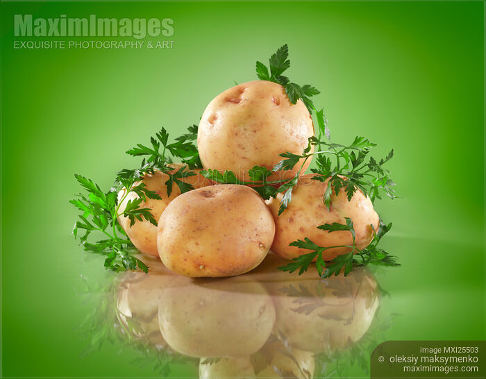 Stock photo of Potatoes on green background Buy commercial use license at MaximImages