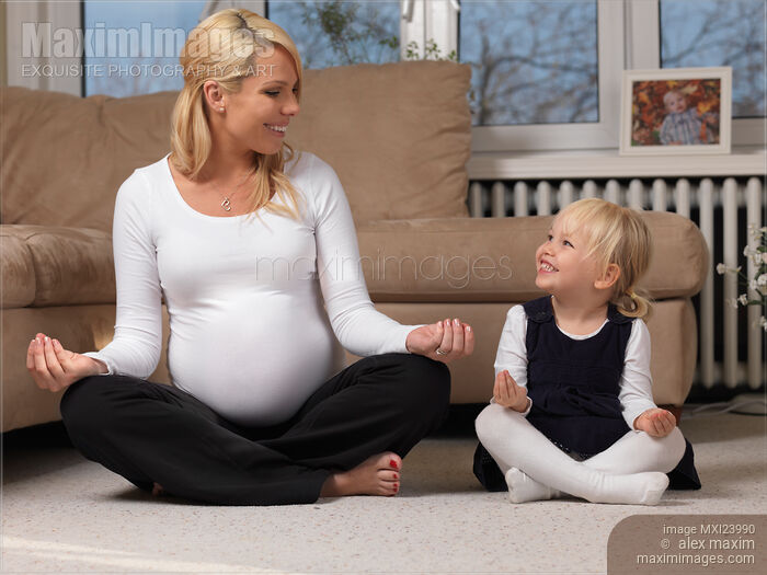 Stock photo of Pregnant mother and little daughter doing yoga Buy commercial use license at MaximImages