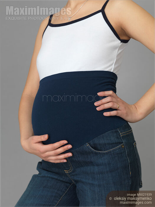 Stock photo of Pregnant Woman Wearing Maternity Jeans Buy commercial use license at MaximImages