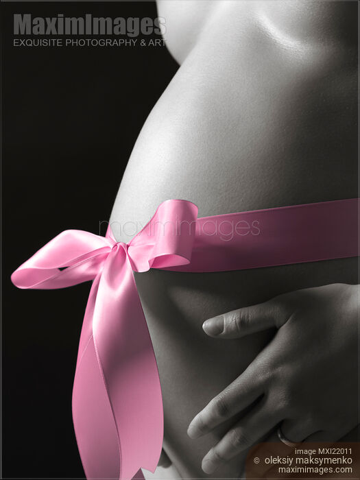 Stock photo of Pregnant Woman with a Bow on Her Belly Buy commercial use license at MaximImages