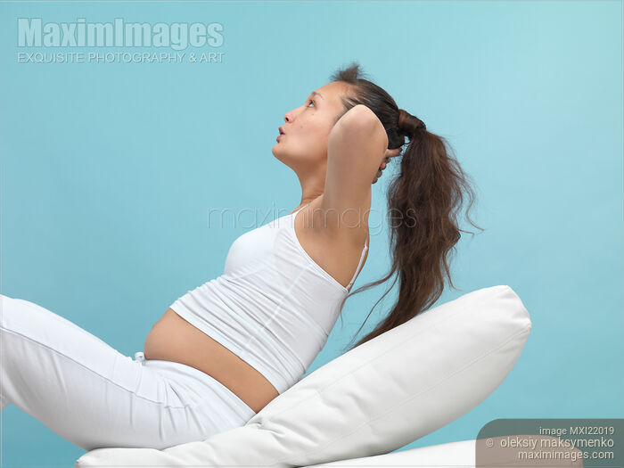 Pregnant Young Woman Exercising Stock photo of Pregnant Young Woman Exercising Buy commercial use license at MaximImages