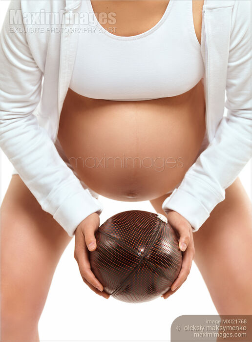 Stock photo of Pregnant Young Woman with a Football Buy commercial use license at MaximImages