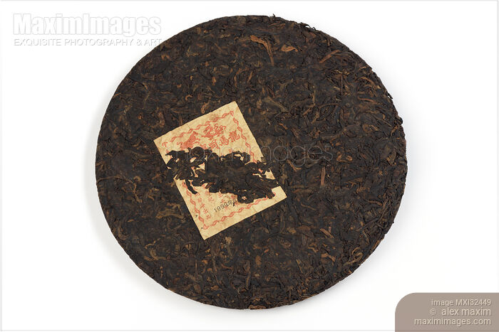 Pu'er or Pu-erh fermented Chinese tea aged for over 20 years pressed into a round disc shape Bingcha Stock photo of Pu'er or Pu-erh fermented Chinese tea aged for over 20 years pressed into a round disc shape Bingcha Buy commercial use license at MaximImages