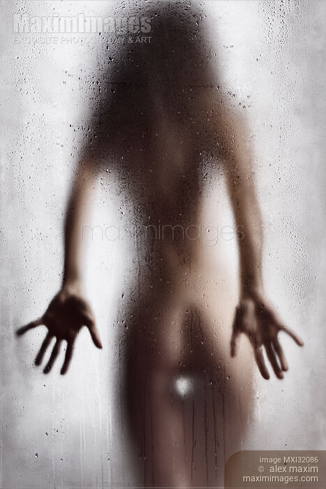 Stock photo of Rear view of nude sexy woman in a provocative pose standing behind wet shower glass Buy commercial use license at MaximImages