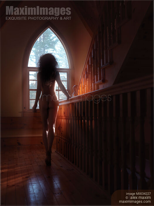 Rear view silhouette of beautiful naked woman walking to a staircase window in dim sunlight Stock photo of Rear view silhouette of beautiful naked woman walking to a staircase window in dim sunlight Buy commercial use license at MaximImages
