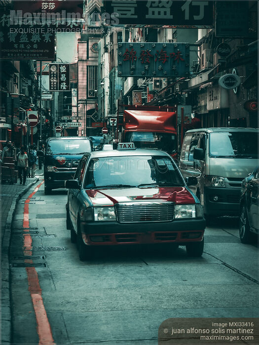 Stock photo of Red Cab taxi car on busy streets of Hong Kong, China Buy commercial use license at MaximImages