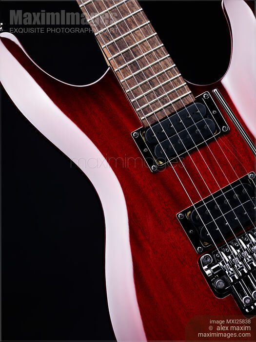 Stock photo of Red electric guitar closeup Buy commercial use license at MaximImages