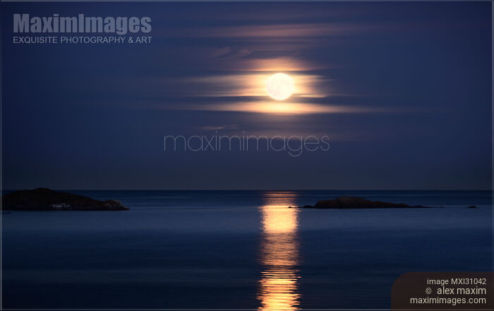 Red Full Harvest Moon rising above Pacific ocean in autumn Stock photo of Red Full Harvest Moon rising above Pacific ocean in autumn Buy commercial use license at MaximImages