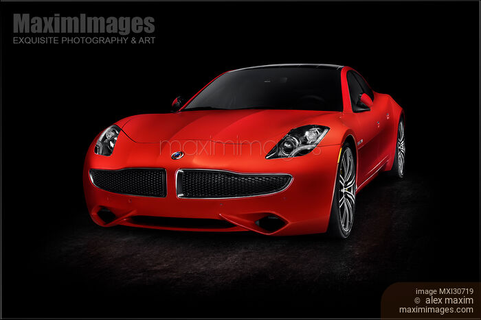 Stock photo of Red Karma Revero plug-in hybrid electric luxury car sports sedan isolated on black Buy commercial use license at MaximImages