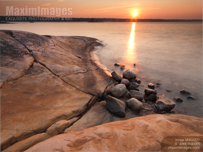 Red rocks on a shore of Georgian Bay during sunrise Stock photo of Red rocks on a shore of Georgian Bay during sunrise Buy commercial use license at MaximImages