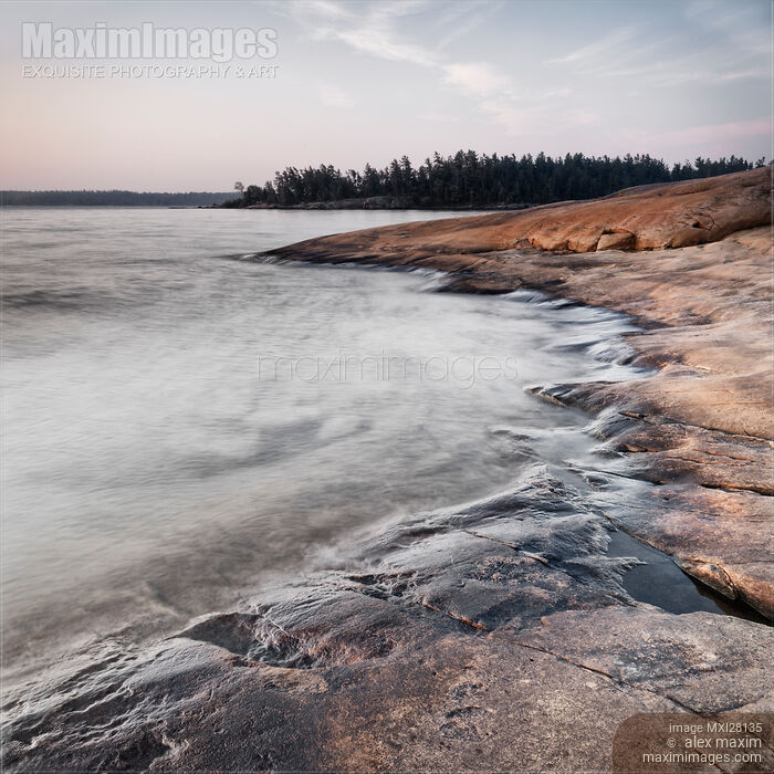 Stock photo of Red rocks on shore of Georgian Bay at dawn Buy commercial use license at MaximImages