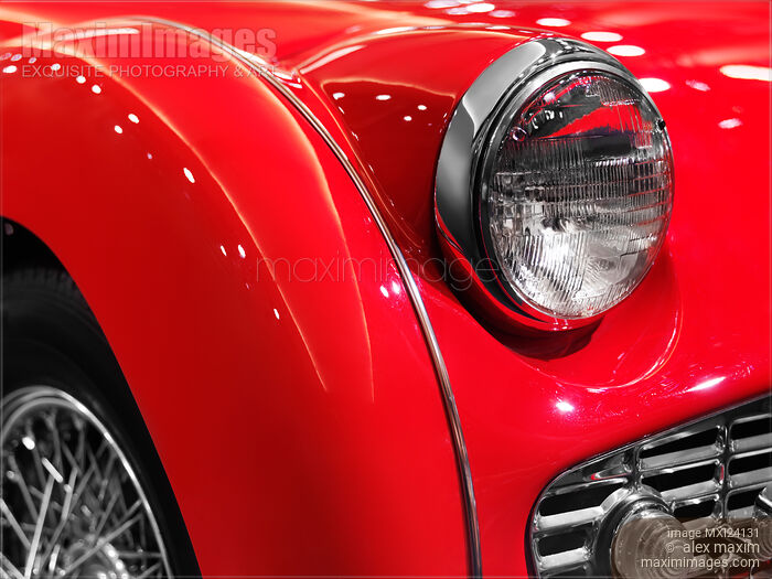 Stock photo of Red Triumph classic retro car detail Buy commercial use license at MaximImages