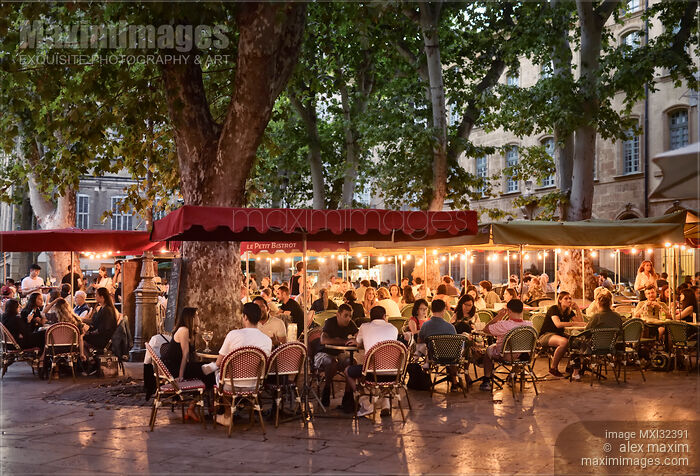 Stock photo of Restaurant terrace busy with people in Aix-en-Provence South France in the evening Buy commercial use license at MaximImages