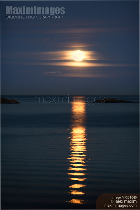 Stock photo of Rise of the Full Harvest Moon above Pacific ocean Buy commercial use license at MaximImages