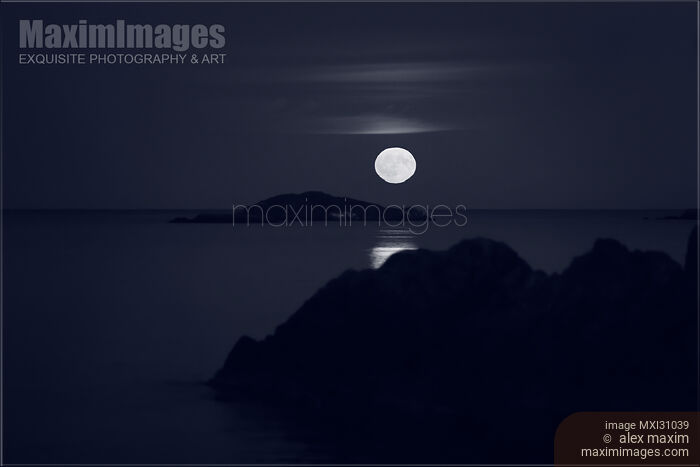 Stock photo of Rising big Full Harvest Moon above Pacific ocean Monochrome Buy commercial use license at MaximImages