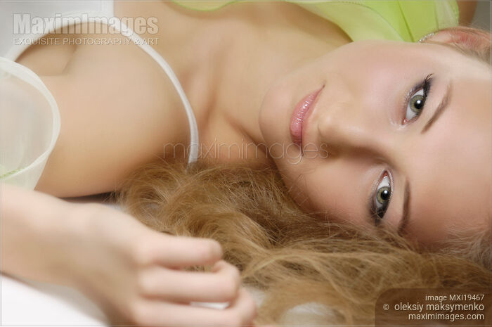 Stock photo of Romantic beauty portrait of young woman lying down Buy commercial use license at MaximImages