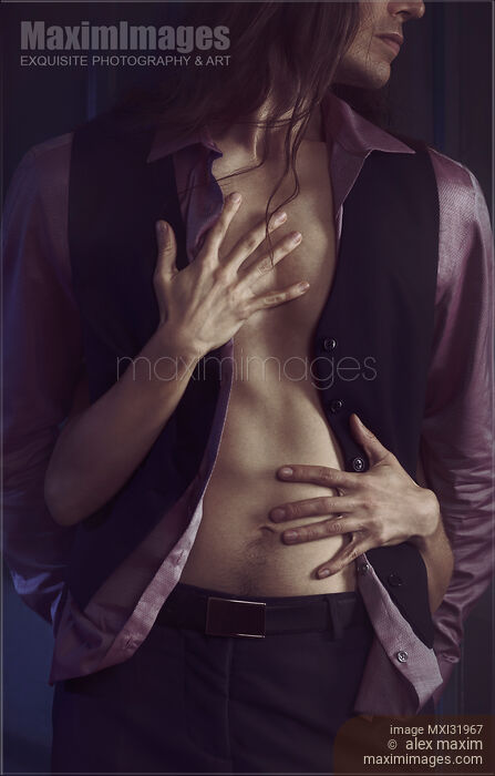 Romantic couple woman hands caressing sexy man body under open shirt and vest in dark from behind Stock photo of Romantic couple woman hands caressing sexy man body under open shirt and vest in dark from behind Buy commercial use license at MaximImages