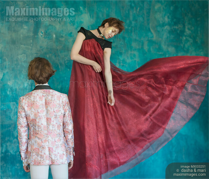 Stock photo of Romantic magician couple, a man and a woman is levitating in beautiful red dress Buy commercial use license at MaximImages