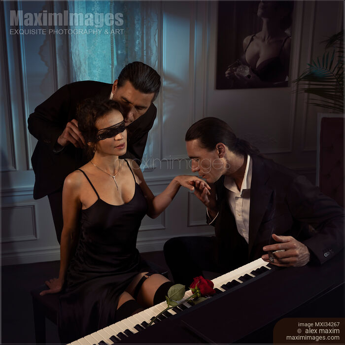 Romantic Menage a trois of two men seducing a beautiful sexy woman sitting at a piano Stock photo of Romantic Menage a trois of two men seducing a beautiful sexy woman sitting at a piano Buy commercial use license at MaximImages