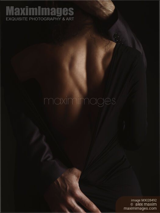 Romantic sensual portrait of couple embracing in dim dramatic light Stock photo of Romantic sensual portrait of couple embracing in dim dramatic light Buy commercial use license at MaximImages