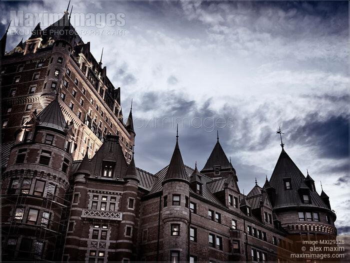 Stock photo of Rooftops of Fairmont Le Château Frontenac in Old Quebec City on a stormy night Buy commercial use license at MaximImages