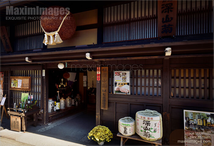Stock photo of Sake brewery entrance at Kamisannomachi old town of Takayama with Sugidama cedar sake ball hanging above Buy commercial use license at MaximImages
