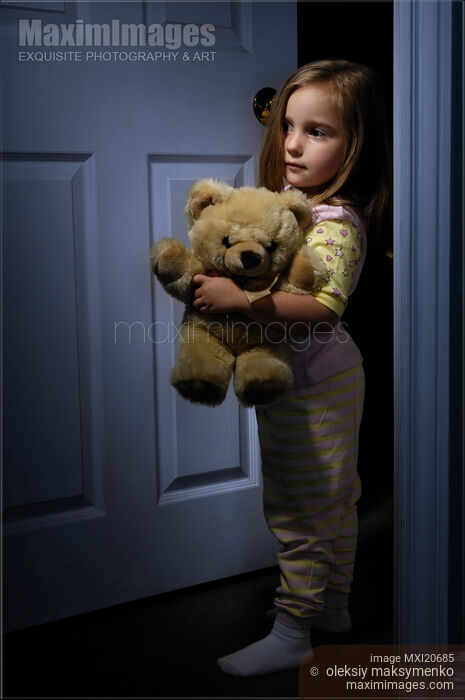 Scared Little Girl Home Alone at Night with a Teddy Bear Stock photo of Scared Little Girl Home Alone at Night with a Teddy Bear Buy commercial use license at MaximImages