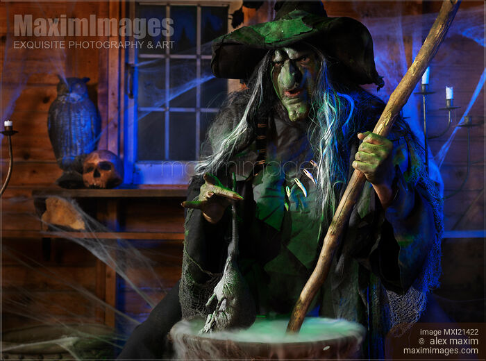 Stock photo of Scary Old Witch with a Cauldron cooking a potion Buy commercial use license at MaximImages