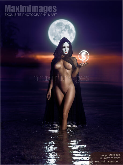 Stock photo of Seductive mysterious snake-like woman in white face mask with sensual nude body walking out of the water like a goddess in full moon Buy commercial use license at MaximImages