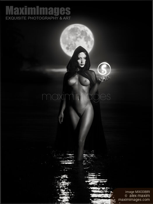Seductive mysterious woman in white face mask with sensual nude body walking out of the water like a goddess in full moon Black and white Stock photo of Seductive mysterious woman in white face mask with sensual nude body walking out of the water like a goddess in full moon Black and white Buy commercial use license at MaximImages