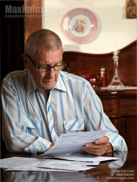 Stock photo of Senior Looking Through Bills Buy commercial use license at MaximImages