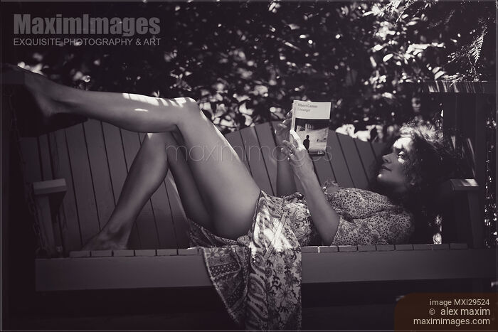 Sensual black and white portrait of a woman reading book on garden bench Stock photo of Sensual black and white portrait of a woman reading book on garden bench Buy commercial use license at MaximImages