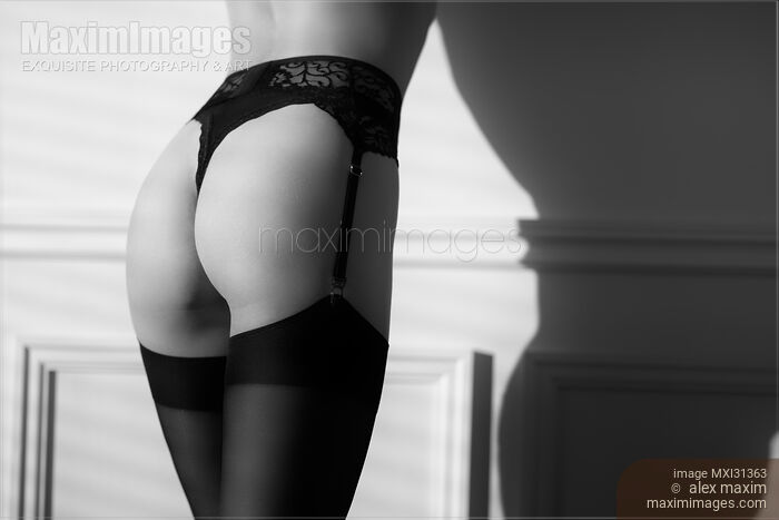 Stock photo of Sensual body parts of a woman wearing sexy black lingerie and stockings black and white closeup of butt Buy commercial use license at MaximImages